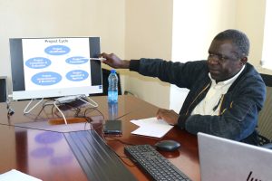 Monitoring and Evaluation Specialist Mr. Jason Wekesa facilitating training on project management